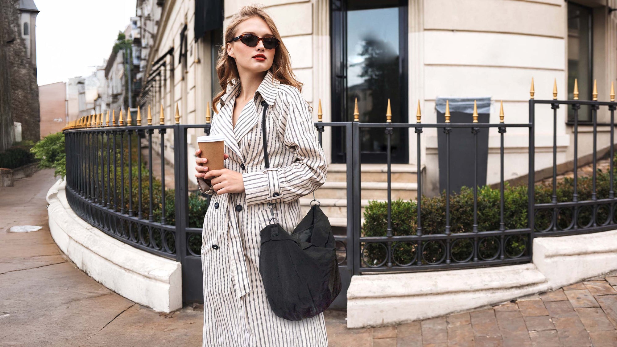french woman wearing a black calla bag